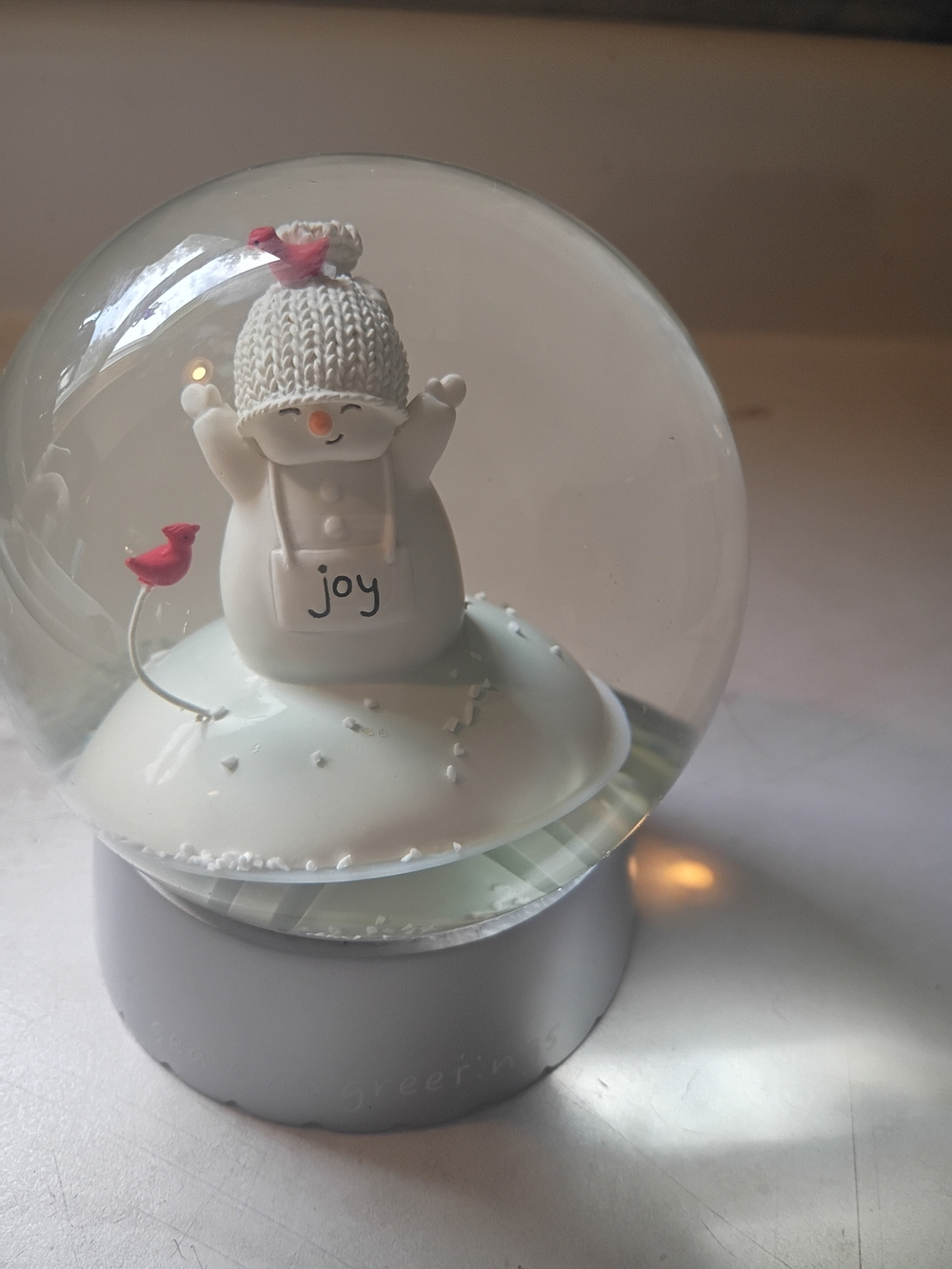 Holiday Living snowman snow globe featuring a white snowman